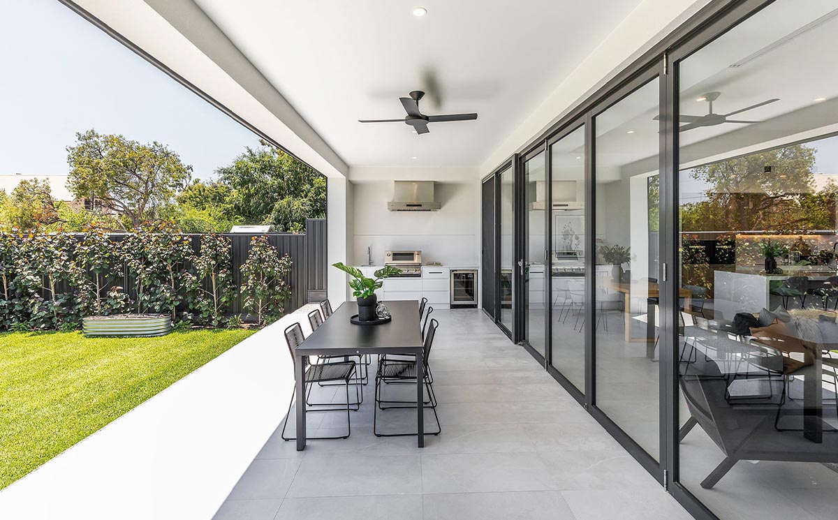 Modern Villa Covered Patio with Large Glass Wall and Outdoor Dining Space Modern Villa Covered Patio with Large Glass Wall and Outdoor Dining Space