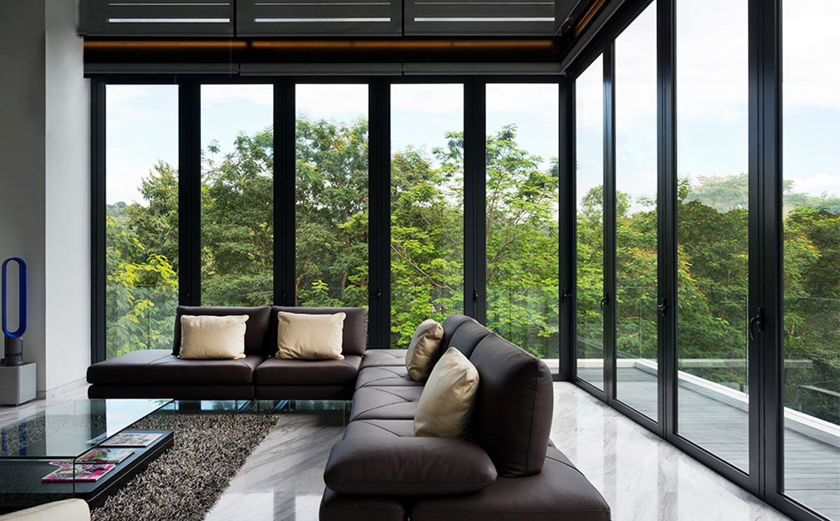 Luxury Villa Living Room with Panoramic Corner Folding Glass Doors Looking at Greenery Luxury Villa Living Room with Panoramic Corner Folding Glass Doors Looking at Greenery