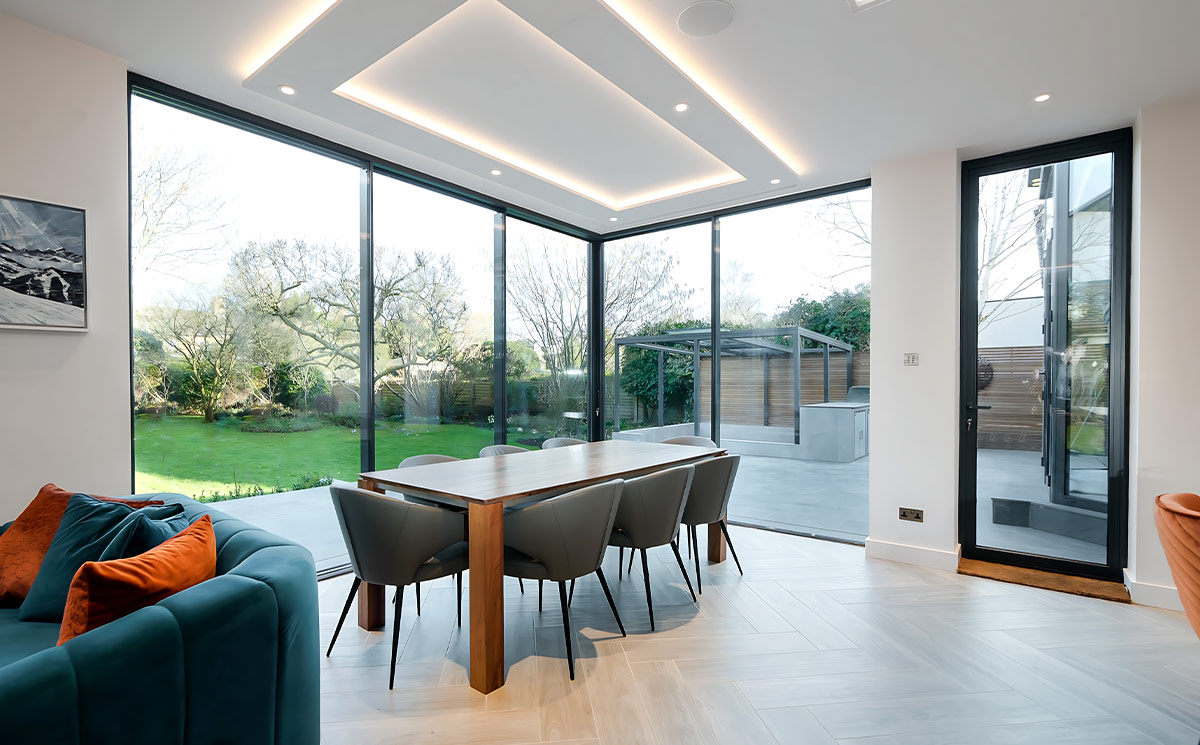 Corner openable ultra slim sliding door system in modern luxury dining room Corner openable ultra slim sliding door system in modern luxury dining room