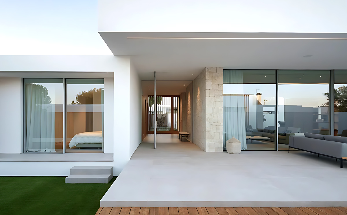Luxury villa exterior facade featuring slim frame sliding doors and open patio terrace Luxury villa exterior facade featuring slim frame sliding doors and open patio terrace