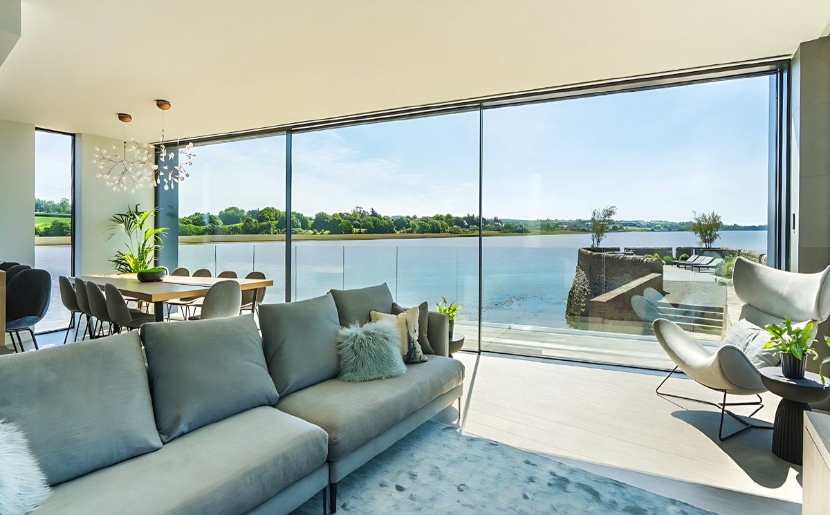 Panoramic ultra slim sliding door system in luxury waterfront villa with lake view Panoramic ultra slim sliding door system in luxury waterfront villa with lake view