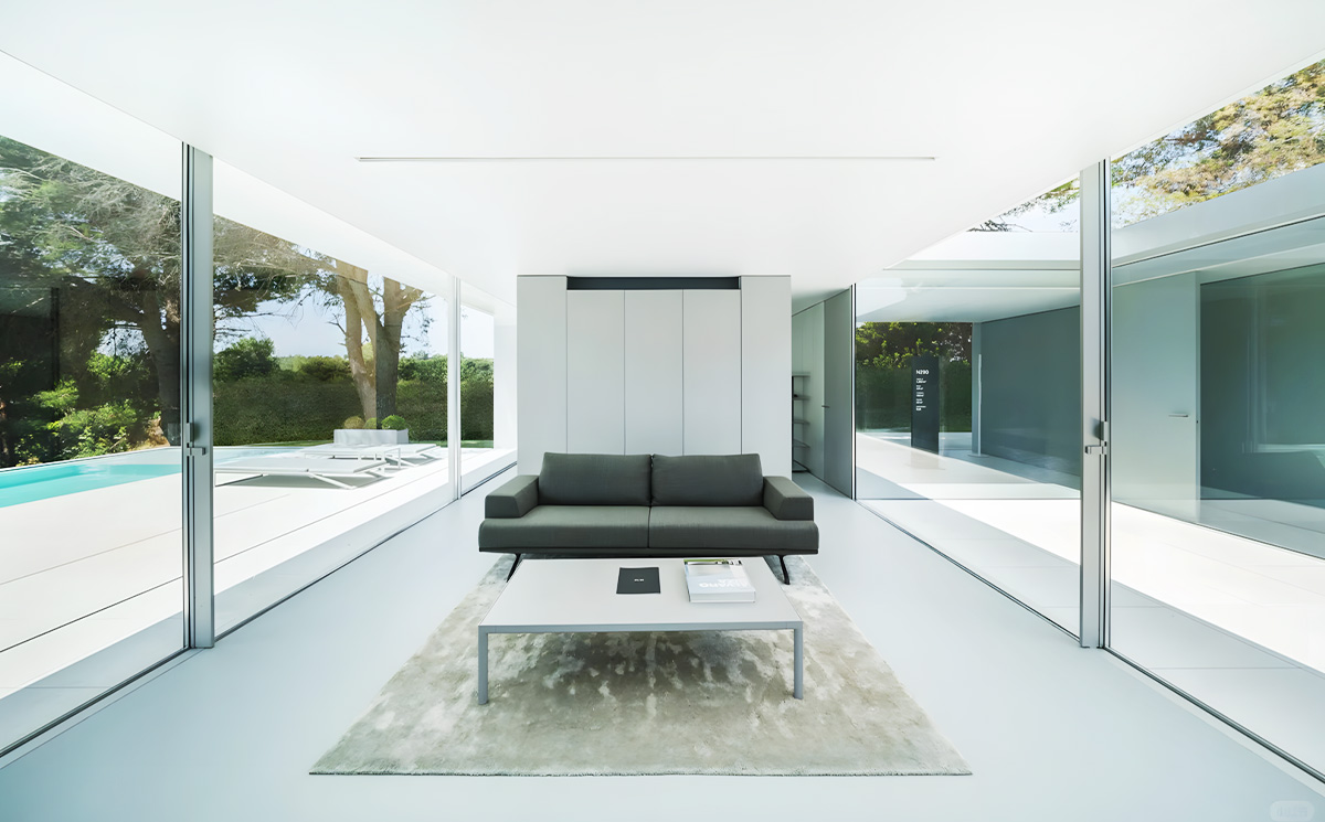 Minimal frame sliding door system installed in modern luxury home living room with open views Minimal frame sliding door system installed in modern luxury home living room with open views